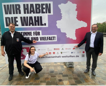 Menschen vor einem Plakat