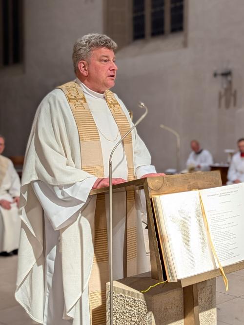 Ein Priester predigt am Ambo