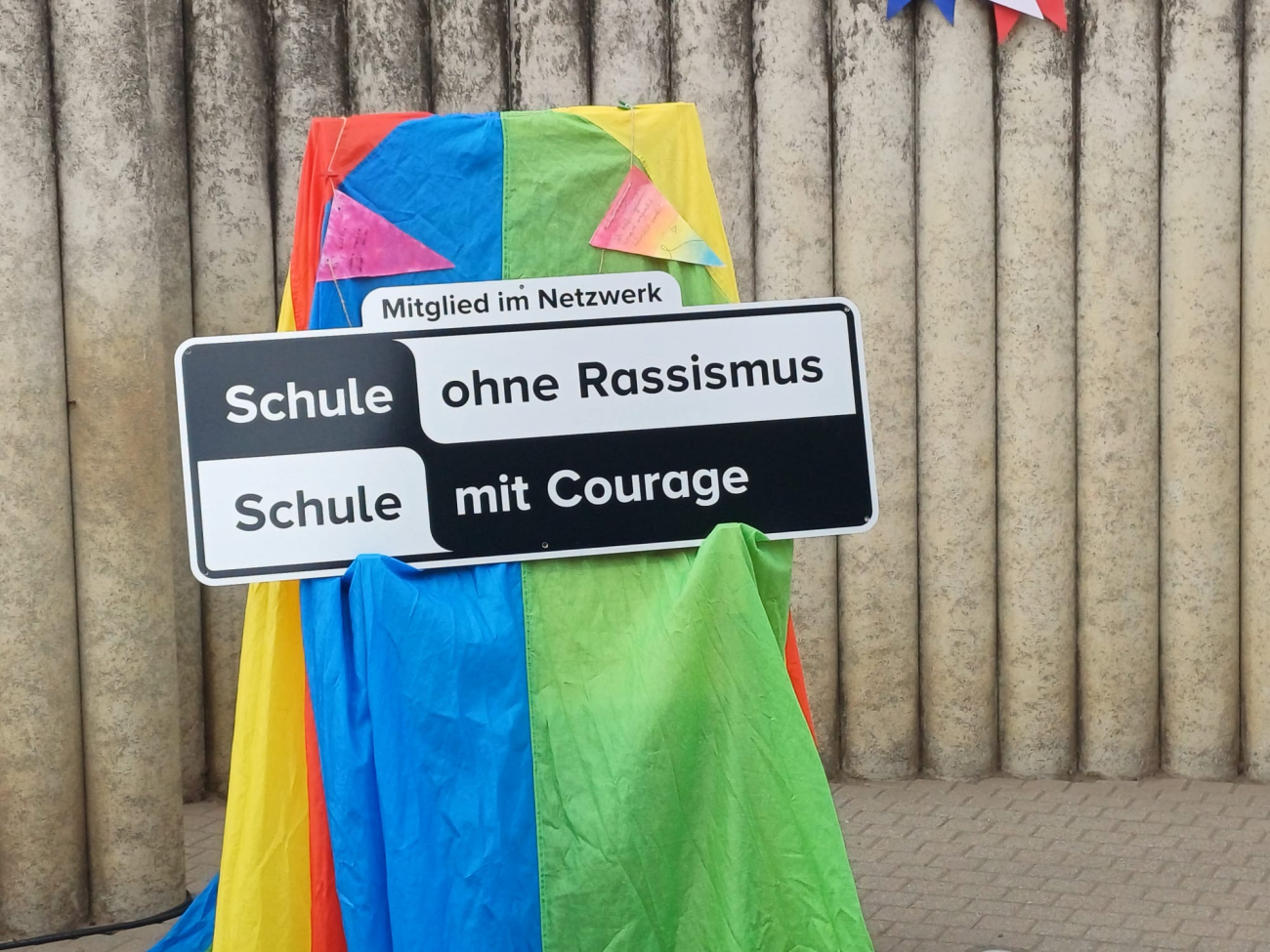 Ein Schild auf bunten Tüchern